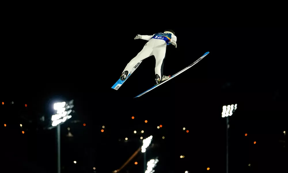 Domen Prevc, of Slovenia, soars through the air during his first round jump of the ski jumping men's super team competition at the 2026 Winter Olympics, in Predazzo, Italy, Monday, Feb. 16, 2026. (AP Photo/Matthias Schrader)