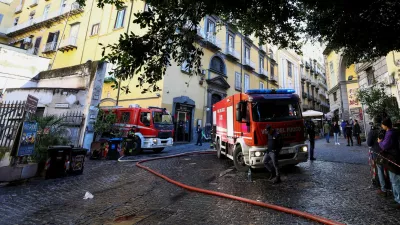 Firetrucks stand next to the historic wood-framed Teatro Sannazaro damaged by fire, in Naples, Italy, February 17, 2026. REUTERS/Ciro De Luca