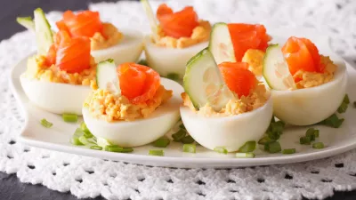 Eggs stuffed with salmon close-up on a plate on the table. horizontal / Foto: Alleko
