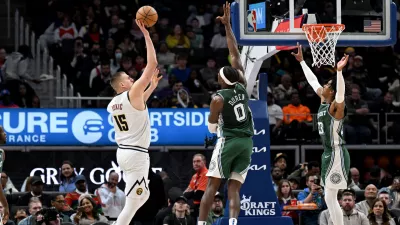 Mar 16, 2023; Detroit, Michigan, USA; Denver Nuggets center Nikola Jokic (15) shoots the ball over Detroit Pistons center Jalen Duren (0) and Detroit Pistons guard Jaden Ivey (23) in the fourth quarter at Little Caesars Arena. Mandatory Credit: Lon Horwedel-USA TODAY Sports