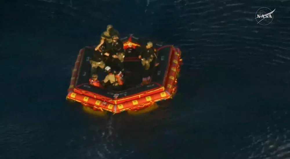 Commander Reid Wiseman awaits to be transported to the recovery ship after being extracted from the Artemis II capsule by recovery personnel in the Pacific Ocean in this screengrab from a livestream video after the Artemis II crew's flyby of the Moon, April 10, 2026. NASA/Handout via REUTERS THIS IMAGE HAS BEEN SUPPLIED BY A THIRD PARTY