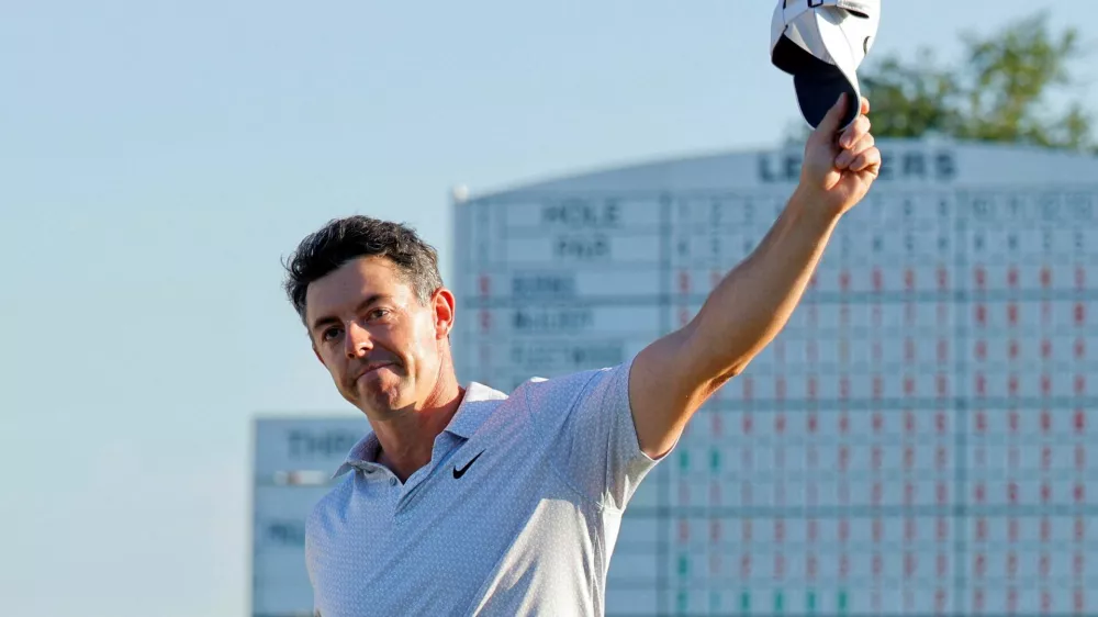 Golf - The Masters - Augusta National Golf Club, Augusta, Georgia, U.S. - April 10, 2026 Northern Ireland's Rory McIlroy celebrates on the 18th hole during the second round as the scoreboard is seen REUTERS/Mike Blake   TPX IMAGES OF THE DAY