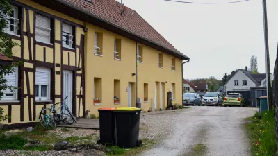 Outside view of the building and the parking area where a 9-year-old boy was rescued after living locked in his father's utility van since 2024, in Hagenbach, Eastern France, Saturday, April 11, 2026. (AP Photo)