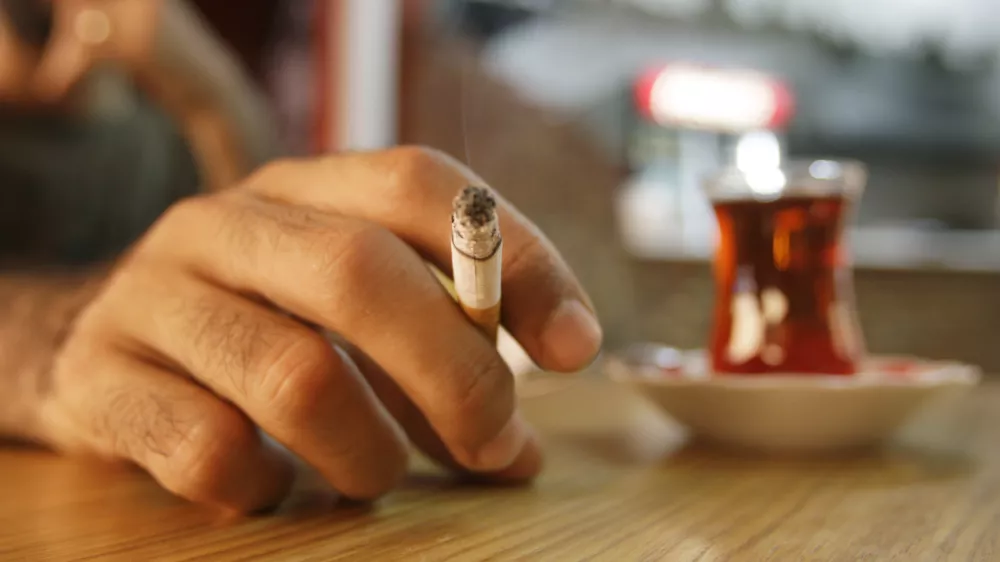 A Turkish man smokes a cigarette at a teahouse in Istanbul, Turkey, Friday, July 17, 2009, two days before a ban on smoking in bars, restaurants and coffeehouses. Turkey's government is setting up a 4,500-strong team to help enforce the upcoming no-smoking ban in this country of heavy smokers. On July 19, a year-old ban on indoor public smoking will be widened to include bars, restaurants, and even traditional smoky, hazy village coffeehouses.(AP Photo/Ibrahim Usta)