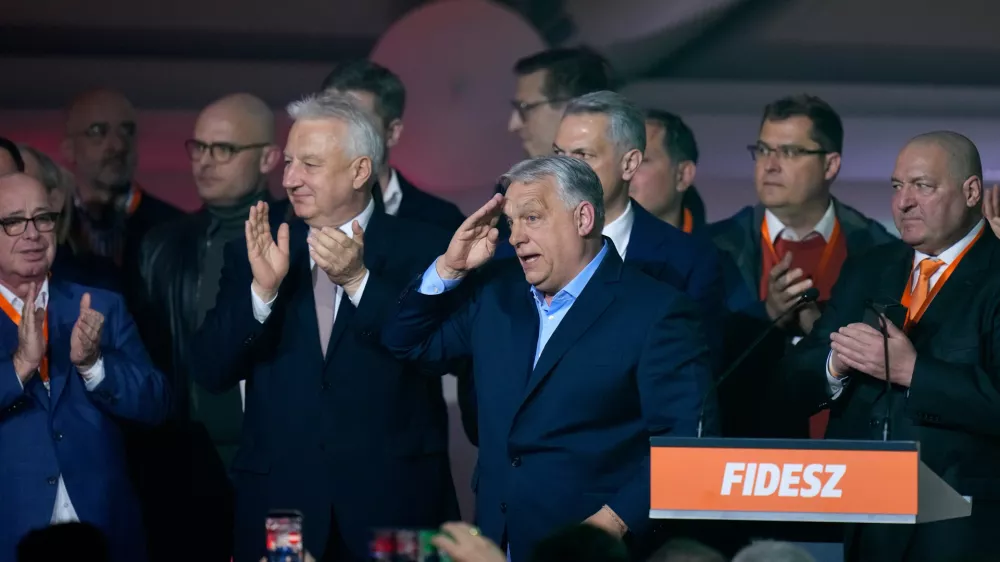 Hungary's Prime Minister Viktor Orban, center, flanked by his team reacts after a parliamentary election in Budapest, Hungary, Sunday, April 12, 2026. (AP Photo/Petr David Josek)