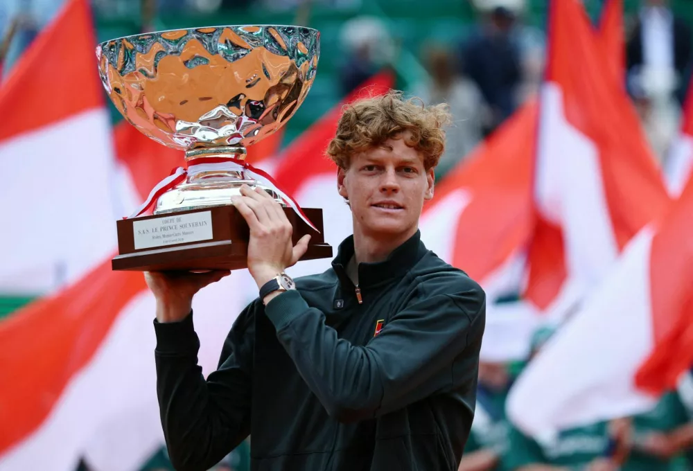 Tennis - ATP Masters 1000 - Monte Carlo Masters - Monte Carlo Country Club, Roquebrune-Cap-Martin, France - April 12, 2026 Italy's Jannik Sinner celebrates with the trophy after winning his final match against Spain's Carlos Alcaraz REUTERS/Manon Cruz  TPX IMAGES OF THE DAY