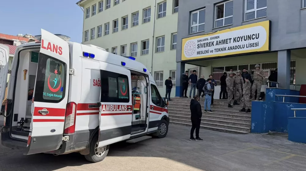 Turkish security forces and emergency staff stand at the courtyard of a high school where an assailant opened fire, in Siverek, south east Turkey, Tuesday, April 14, 2026, (Mevlut Bayraktar/IHA via AP)
