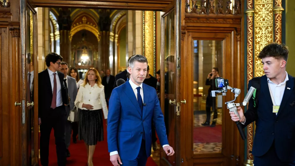 Prime Minister-elect Peter Magyar, the Tisza Party's leader, center, leaves the preparatory meeting for the inaugural session of the Parliament at the Parliament building in Budapest, Hungary, Friday, April 17, 2026. (Robert Hegedus/MTI via AP)