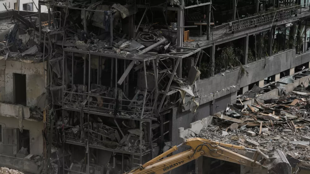 FILE - An excavator removes rubble from destroyed buildings that were hit by Israeli airstrikes on Thursday, as rescuers search for victims in the city of Tyre, southern Lebanon, Saturday, April 18, 2026. (AP Photo/Bilal Hussein, File)