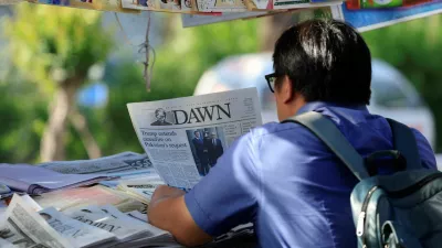 A person reads a newspaper, after U.S. President Donald Trump said he would indefinitely extend the ceasefire with Iran, as Pakistan prepares to host the U.S. and Iran for the second phase of peace talks in Islamabad,Pakistan April 22, 2026. REUTERS/Akhtar Soomro