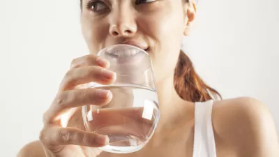Young woman drinking glass of water