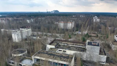 FILE - A dome-shaped shelter covering the damaged reactor at the Chernobyl nuclear plant is seen on the horizon, April 15, 2021, from the abandoned town of Pripyat, Ukraine, once home to some 50,000 people whose lives were connected to the plant. (AP Photo/Efrem Lukatsky, File)