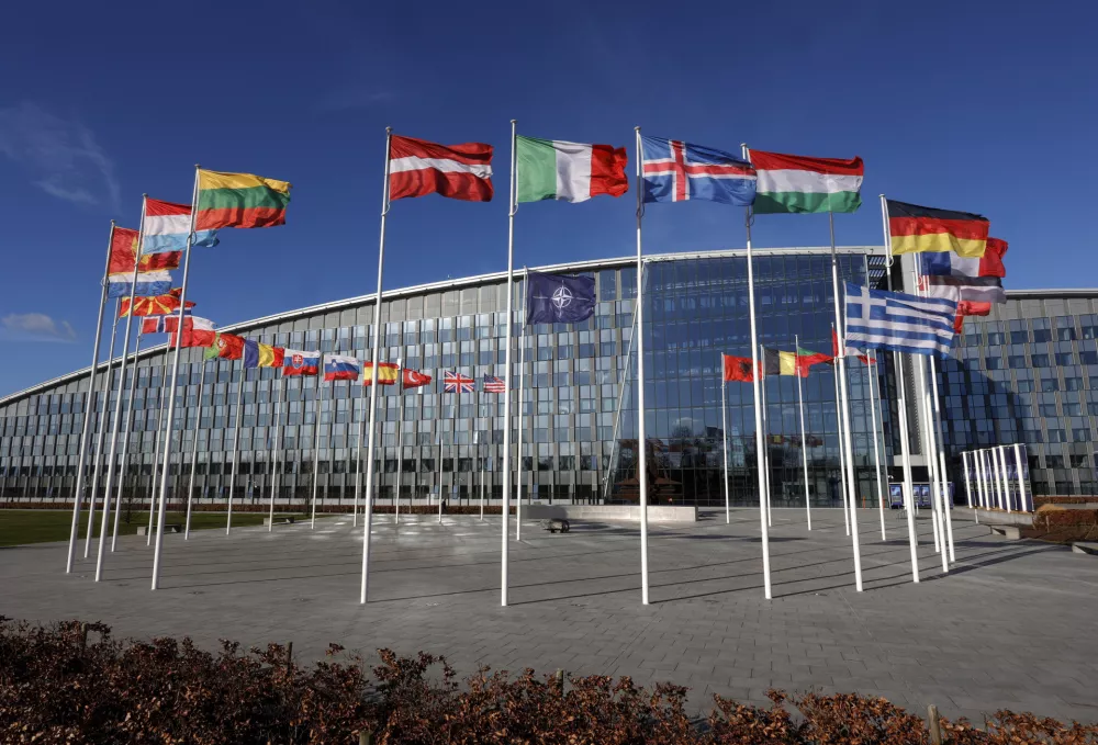 FILE - Flags flutter in the wind outside NATO headquarters in Brussels, Feb. 7, 2022. Finland and Sweden have signaled their intention to join NATO over Russia's war in Ukraine and things will move fast once they formally apply for membership in the world's biggest security alliance. Russian President Vladimir Putin has already made clear that there would be consequences if the two Nordic countries join. (AP Photo/Olivier Matthys, File)