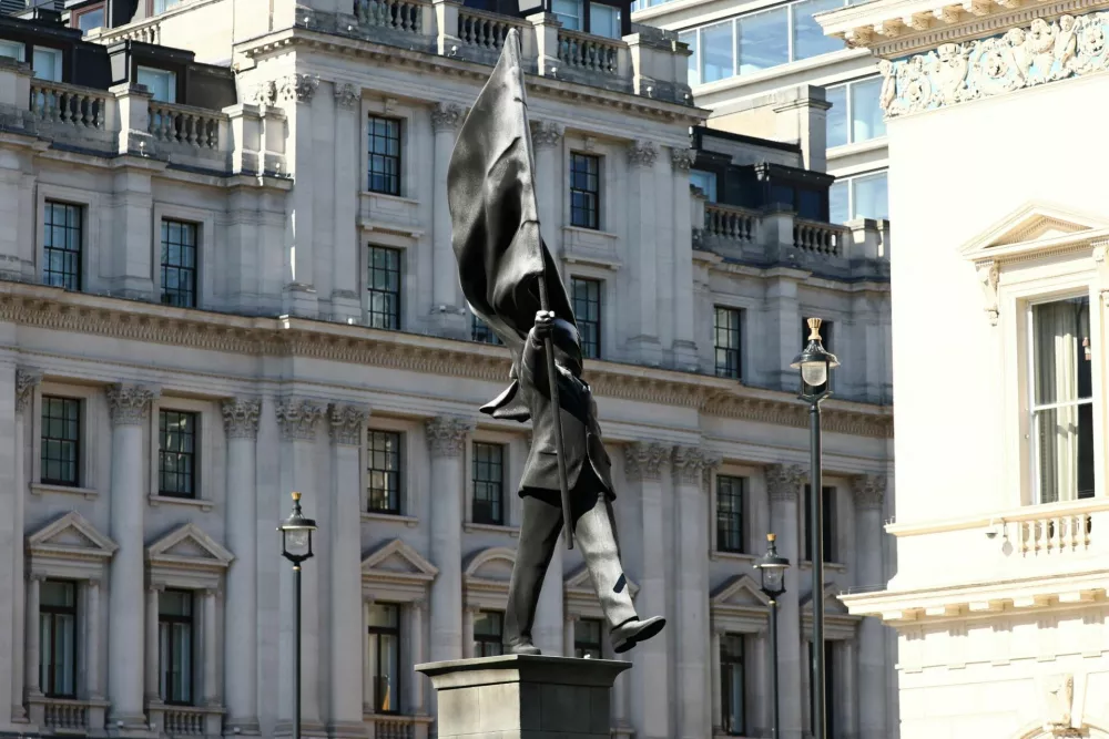 A statue depicting a person stepping off the plinth while carrying a flag covering their face, by British street artist Banksy, stands in London, Britain, April 30, 2026. REUTERS/Jack Taylor