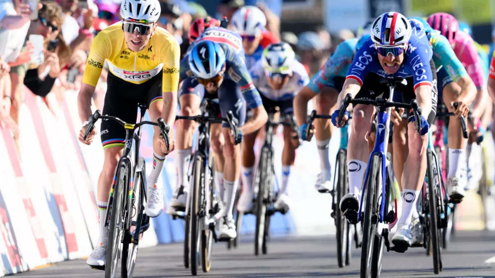 Winner Tadej Pogacar, left, from Slovenia, sprints ahead of second placed Dorion Godon, right, from France, to win the second stage, a 173,1 km race between Rue and Vucherens, of the 79th Tour de Romandie UCI World Tour Cycling race, in Vuillens, Switzerland, Thursday, April 30, 2026. (Laurent Gillieron/Keystone via AP)