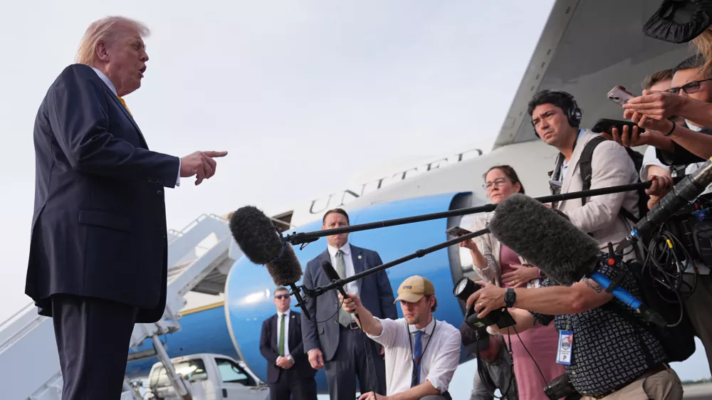 President Donald Trump talks to reporters before he boards Air Force One at Palm Beach International Airport in West Palm Beach, Fla., Saturday May 2, 2026, en route Miami. (AP Photo/Matt Rourke)