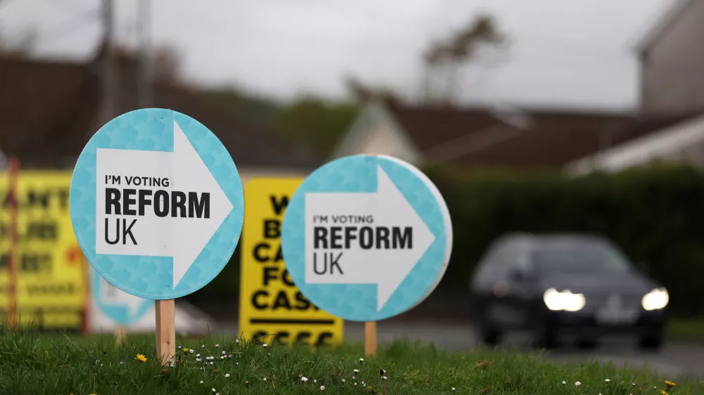 Signs supporting the Reform UK party are displayed outside a car dealership, ahead of the upcoming Senedd (Welsh Parliament) devolved general election, in Caerphilly, south Wales, Britain, April 16, 2026. REUTERS/Toby Melville