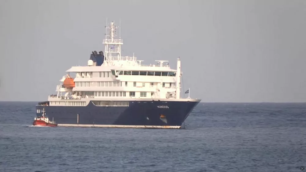 A boat beside cruise ship MV Hondius anchored off Cape Verde port, on the day sick passengers were evacuated by boat from the cruise ship, in Praia Port, Cape Verde, in this screengrab obtained from a video, May 5, 2026. REUTERS TV via REUTERS