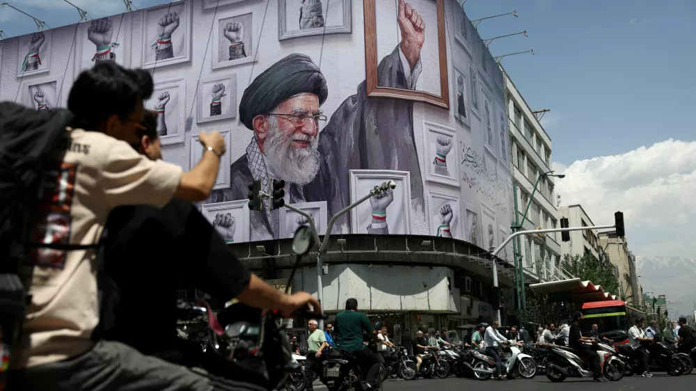 People ride motorcycles near a billboard featuring an image of the late Supreme Leader of Iran, Ayatollah Ali Khamenei, in Tehran, Iran, May 6, 2026. Majid Asgaripour/WANA (West Asia News Agency) via REUTERS ATTENTION EDITORS - THIS PICTURE WAS PROVIDED BY A THIRD PARTY   TPX IMAGES OF THE DAY