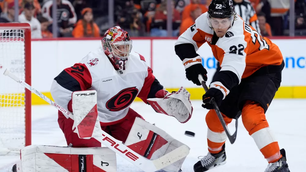 Carolina Hurricanes' Frederik Andersen, left, blocks a shot as Philadelphia Flyers' Christian Dvorak reaches in during the second period of Game 3 in the second round of the NHL hockey Stanley Cup playoffs, Thursday, May 7, 2026, in Philadelphia. (AP Photo/Matt Slocum)