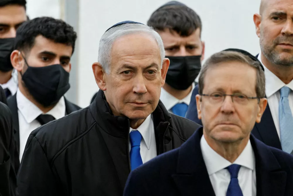 FILE PHOTO: Israeli Prime Minister Benjamin Netanyahu and Israeli President Isaac Herzog attend a memorial service held for Ran Gvili, an off-duty police officer who was killed fighting militants that had infiltrated Israel during the deadly October 7, 2023, attack by Hamas, and the last hostage recovered from Gaza, in Meitar, Israel, January 28, 2026. REUTERS/Amir Cohen/File Photo