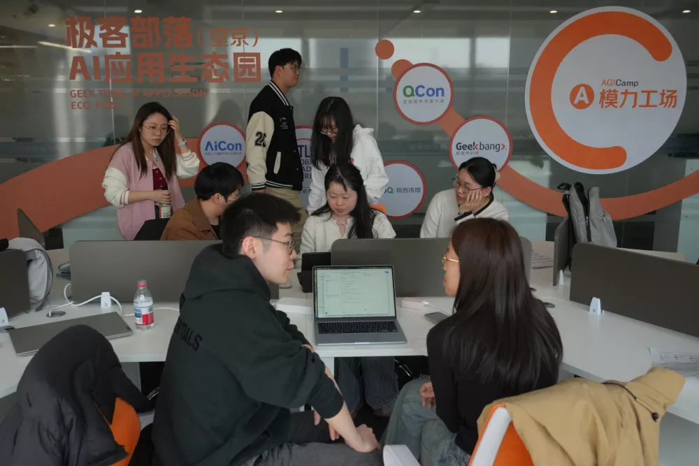 Staff members help their customers install the RedClaw AI software on their laptops in Beijing on March 22, 2026. (AP Photo/Andy Wong)