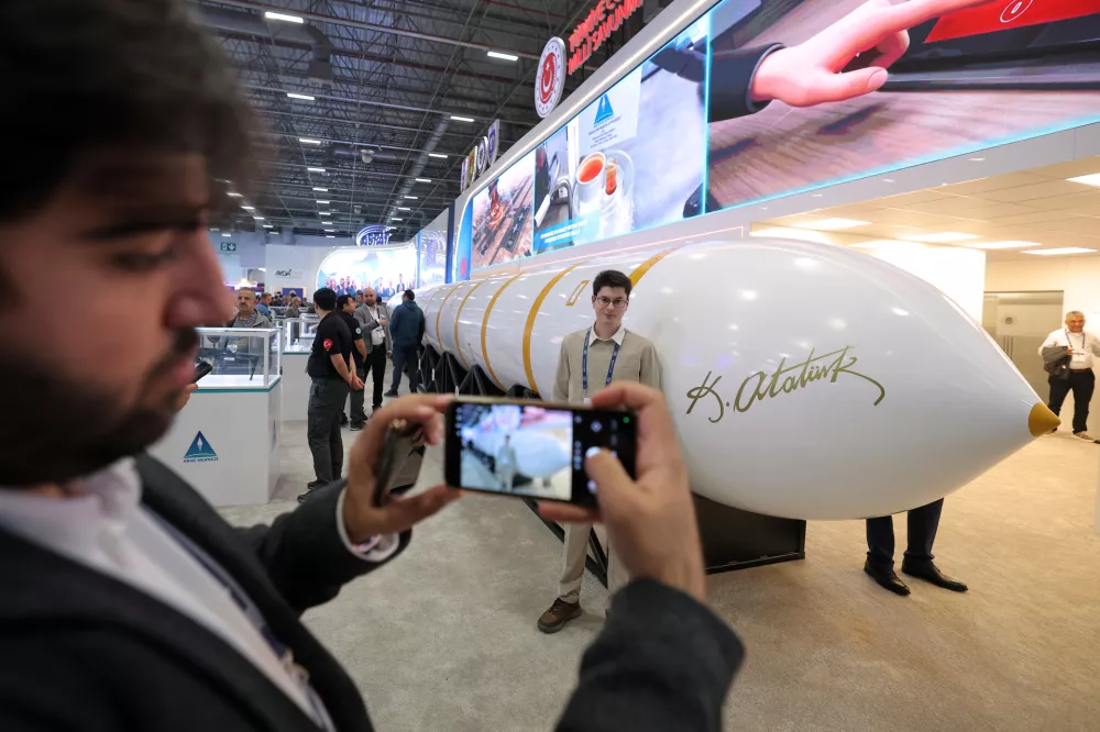 People take photographs next to a Turkish made intercontinental ballistic missile Yildirimhan on display at the SAHA International Defense and Aerospace exhibition in Istanbul, Turkey, Wednesday, May 6, 2026. (AP Photo)