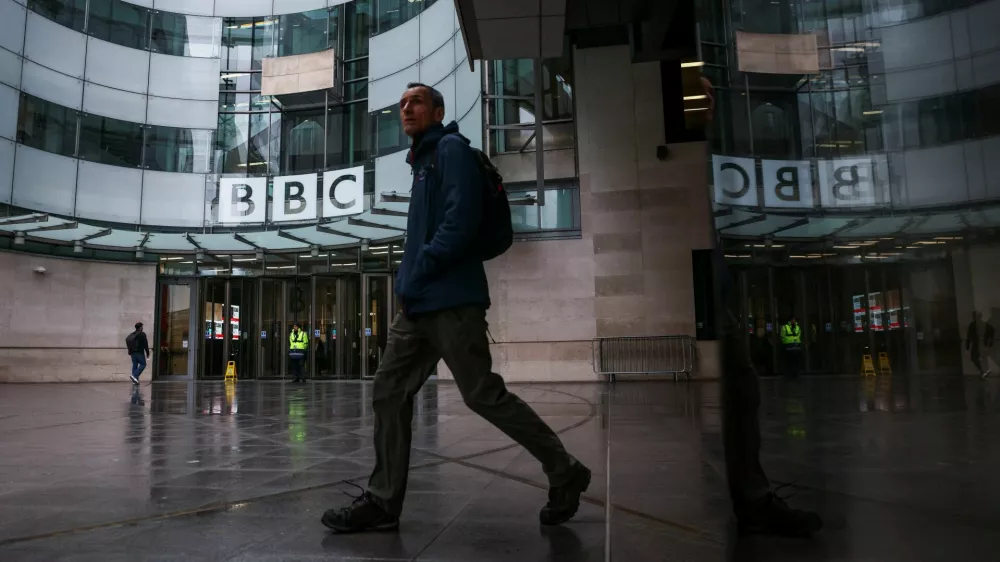 A person walks outside BBC Broadcasting House after Director General of BBC Tim Davie and Chief Executive of BBC News Deborah Turness resigned following accusations of bias at the British broadcaster, including in the way it edited a speech by U.S. President Donald Trump, in London, Britain, November 10, 2025. REUTERS/Jack Taylor