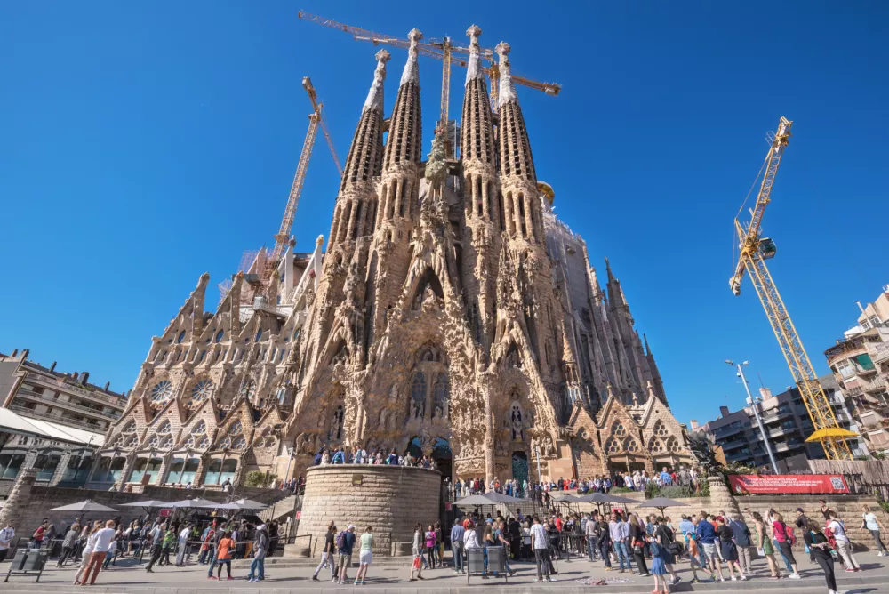 Barcelona, Spain - May 3, 2016: Tourist visiting Cathedral of La Sagrada Familia on May 3, 2016 in Barcelona, Spain. It is designed by architect Antonio Gaudi and is being build since 1882.