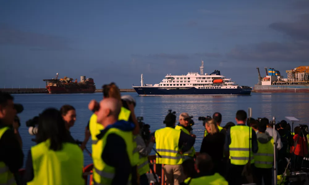Media and emergency services personnel work next the hantavirus-stricken cruise ship MV Hondius after its arrival at the port of Granadilla in Tenerife, Canary Islands, Spain, Sunday, May 10, 2026. (AP Photo/Manu Fernandez)