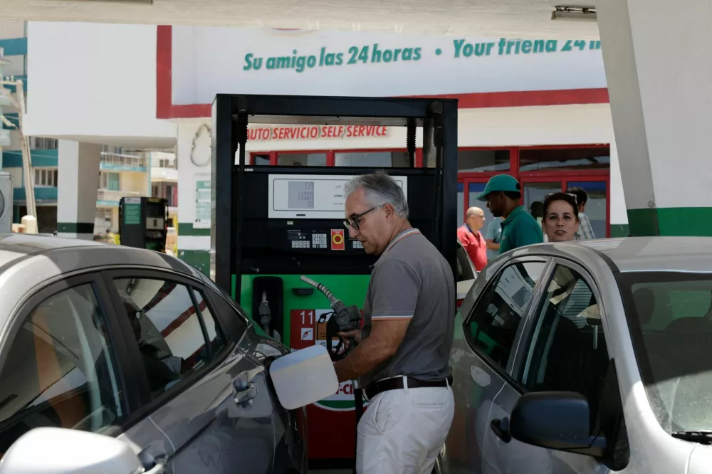 A driver fills up his tank as Cuba announces new and variable fuel prices at the pump beginning on May 15 to better reflect the actual costs of importing gas and diesel amid an ongoing U.S. fuel blockade, in Havana, Cuba, May 12, 2026. REUTERS/Norlys Perez