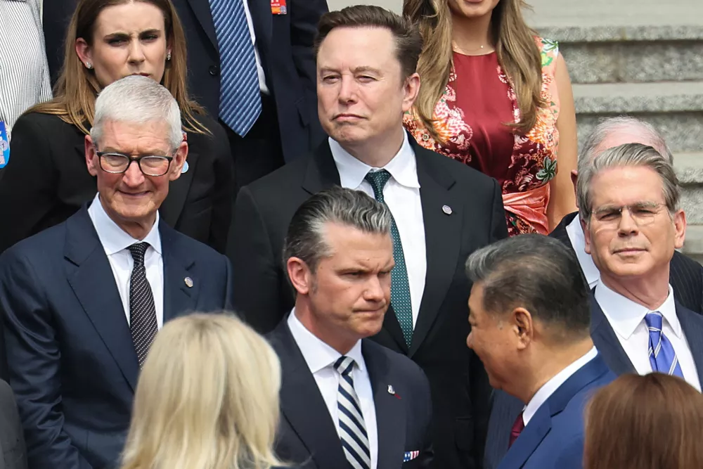 Apple CEO Tim Cook, Tesla CEO Elon Musk, U.S. Defense Secretary Pete Hegseth and U.S. Treasury Secretary Scott Bessent attend the welcome ceremony for U.S. President Donald Trump by Chinese President Xi Jinping, at the Great Hall of the People in Beijing, China May 14, 2026. REUTERS/Maxim Shemetov/Pool