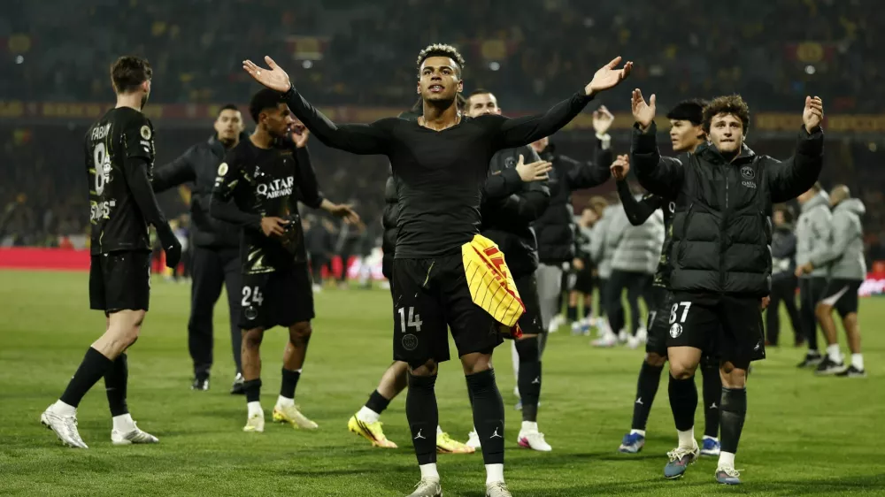 Soccer Football - Ligue 1 - RC Lens v Paris St Germain - Stade Bollaert-Delelis, Lens, France - May 13, 2026  Paris St Germain's Desire Doue and Paris St Germain's Joao Neves celebrate after winning Ligue 1 REUTERS/Benoit Tessier