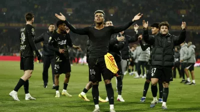 Soccer Football - Ligue 1 - RC Lens v Paris St Germain - Stade Bollaert-Delelis, Lens, France - May 13, 2026  Paris St Germain's Desire Doue and Paris St Germain's Joao Neves celebrate after winning Ligue 1 REUTERS/Benoit Tessier