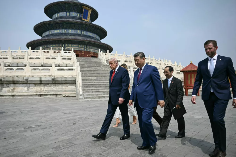 China's President Xi Jinping (C), US President Donald Trump (L) and Eric Trump (R) visit the Temple of Heaven in Beijing on May 14, 2026. BRENDAN SMIALOWSKI/Pool via REUTERS