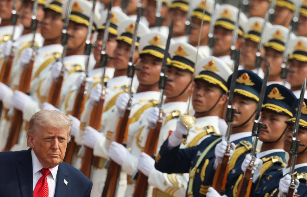 U.S. President Donald Trump inspects an honour guard during a welcome ceremony at the Great Hall of the People in Beijing, Thursday, May 14, 2026. (Maxim Shemetov/Pool Photo via AP)