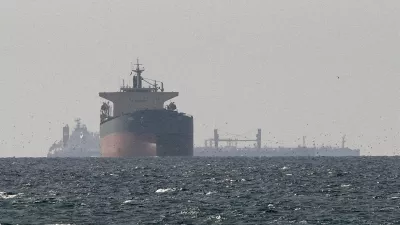 FILE PHOTO: Cargo ships in the Gulf, near the Strait of Hormuz, as seen from northern Ras al-Khaimah, near the border with Oman's Musandam governance, amid the U.S.-Israeli conflict with Iran, in United Arab Emirates, March 11, 2026./File Photo