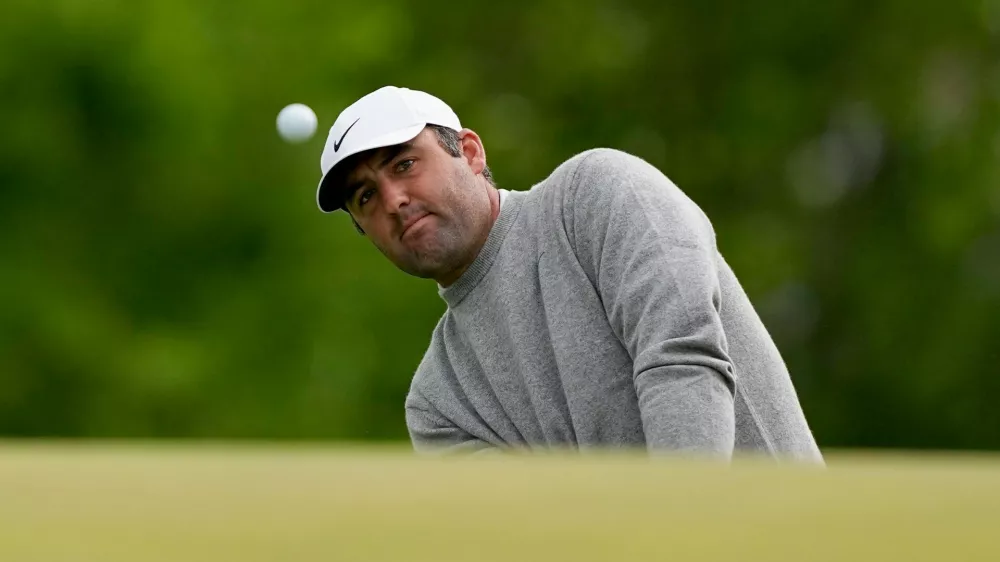 Scottie Scheffler chips onto the ninth green during the first round of the PGA Championship golf tournament at Aronimink Golf Club, Thursday, May 14, 2026, in Newtown Square, PA. (AP Photo/Carolyn Kaster)