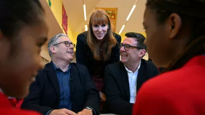 FILE - Britain's Prime Minister Keir Starmer, left, former deputy prime minister Angela Rayner and Manchester Mayor Andy Burnham meet with school children at a primary school in Ashton-under-Lyne, north-west England, Monday April 13, 2026. (Paul Ellis/Pool Photo via AP, File)