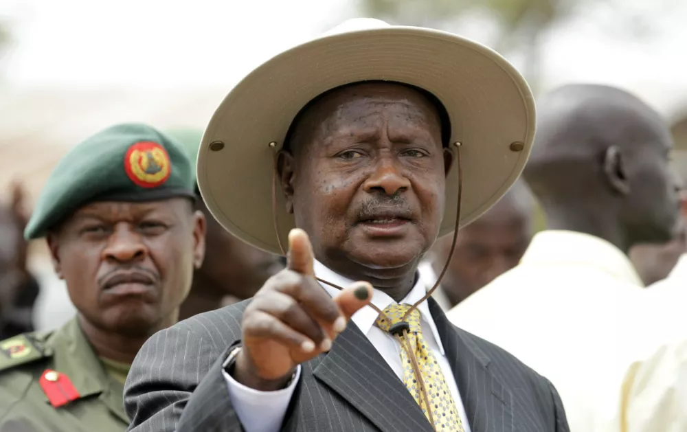 Uganda's President Yoweri Museveni talks to the media after casting his ballot at a polling centre in Kaaro High School in Rushere, Kiruhura district, about 300 km (186 miles) west of the capital Kampala, February 18, 2011. Ugandans voted in an election on Friday expected to hand Museveni a fourth term in office but which has been marred by allegations of rampant bribery and fears the process could turn nasty. REUTERS/Thomas Mukoya (UGANDA - Tags: ELECTIONS POLITICS)