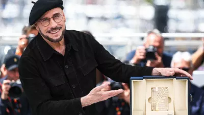 Director John Travolta poses with his Honorary Palm d'Or during a photocall for the film "Propeller One-Way Night Coach" (Vol de Nuit pour Los Angeles) presented as part of Cannes Premiere at the 79th Cannes Film Festival in Cannes, France, May 16, 2026. REUTERS/Manon Cruz