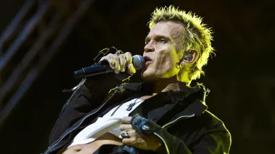 Britain's singer Billy Idol performs in the rain at the Sweden Rock festival in Solvesborg, Sweden, Friday June 11, 2010. (AP Photo/Claudio Bresciani/SCANPIX) ** SWEDEN OUT **