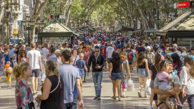 Barcelona, Spain - July 5, 2016: Hundreds of people promenading in the busiest street of Barcelona, the Ramblas. The street extends 1.2 kilometers connects the Placa de Catalunya in the centre with the Christopher Columbus Monument at Port Vell.