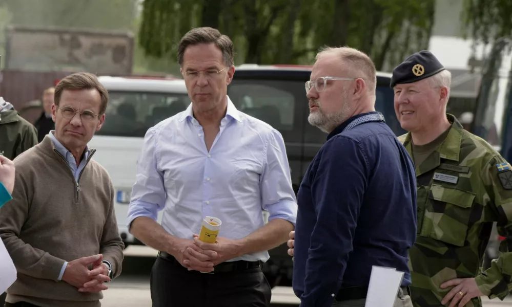 NATO Secretary General Mark Rutte and Swedish Prime Minister Ulf Kristersson look at a civil alarm system during a visit to Revinge, Sweden, May 21, 2026. REUTERS/Tom Little
