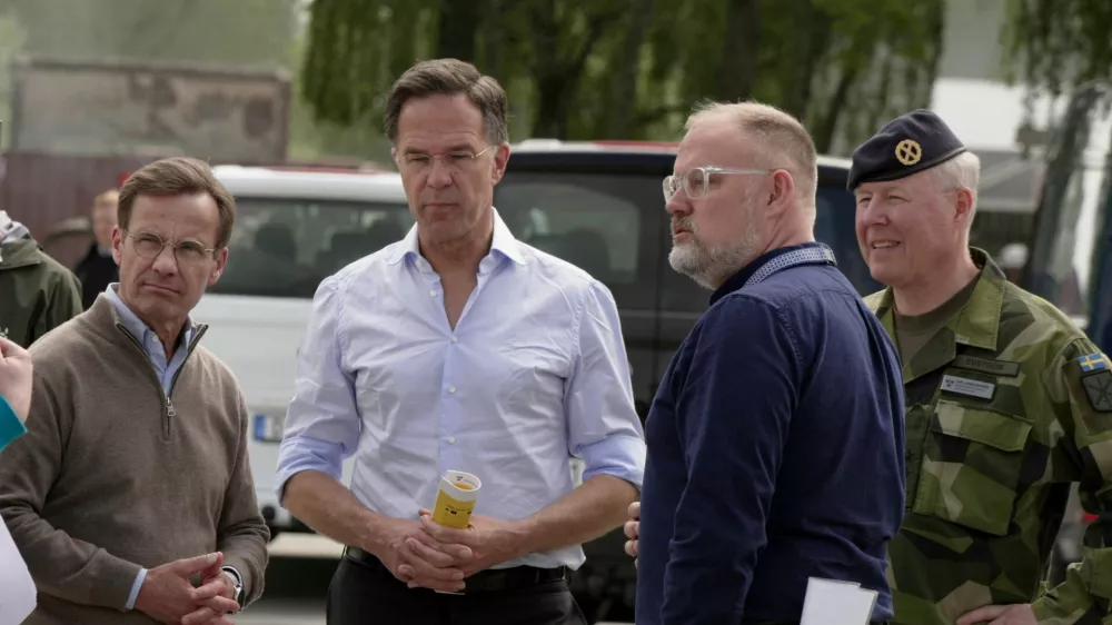 NATO Secretary General Mark Rutte and Swedish Prime Minister Ulf Kristersson look at a civil alarm system during a visit to Revinge, Sweden, May 21, 2026. REUTERS/Tom Little