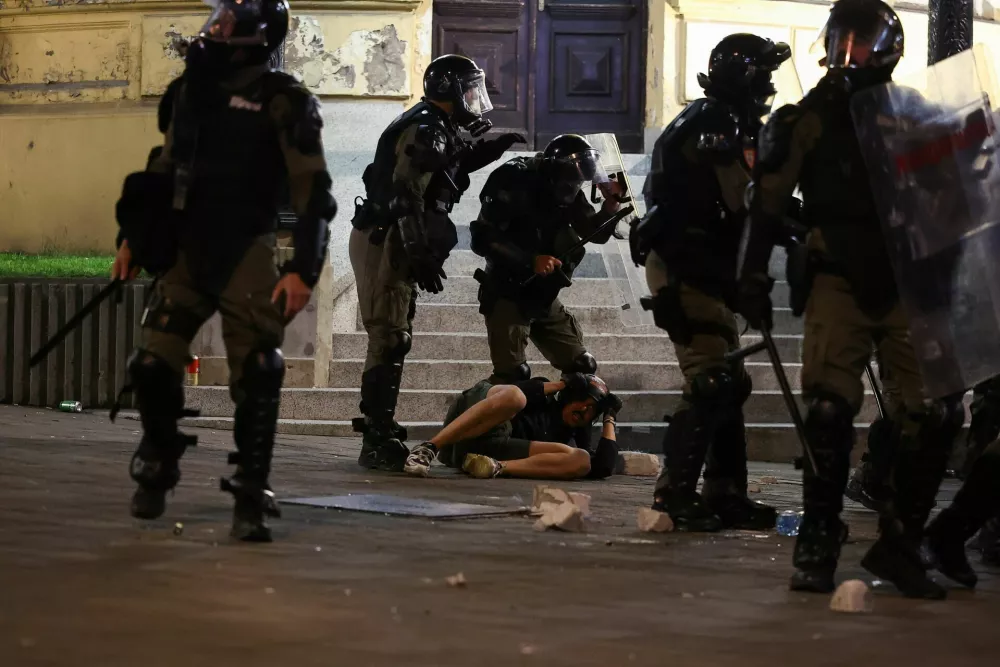 A demonstrator lies on the ground next to members of the Gendarmery, during a student-led protest demanding snap parliamentary elections, as Serbia's anti-corruption movement enters a new phase, following the Novi Sad railway station canopy collapse that killed 16 people in 2024, in Belgrade, Serbia, May 23, 2026. REUTERS/Zorana Jevtic