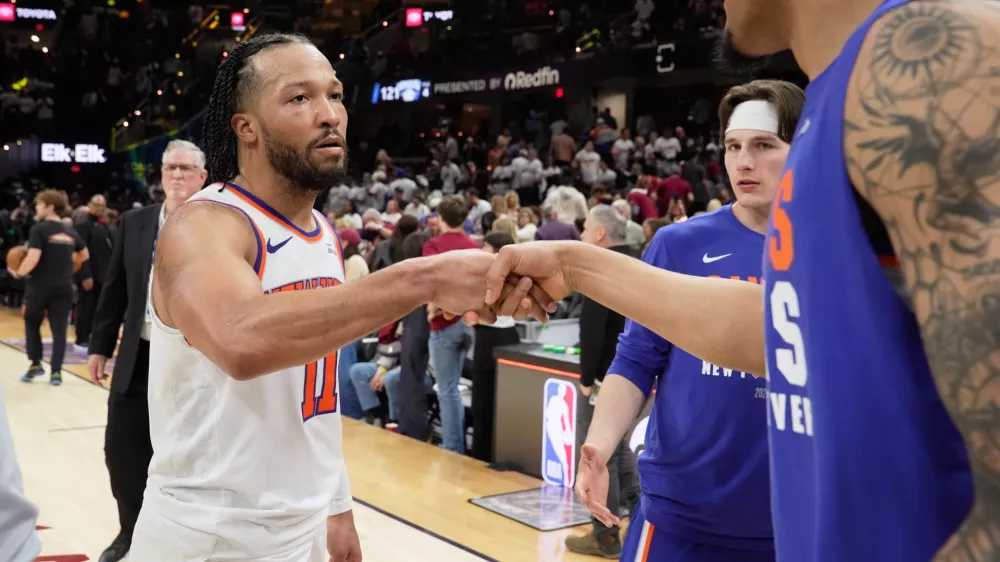 New York Knicks guard Jalen Brunson (11) celebrates with teammates after winning Game 3 in the Eastern Conference finals NBA basketball playoffs series against the Cleveland Cavaliers in Cleveland, Saturday, May 23, 2026. (AP Photo/Sue Ogrocki)