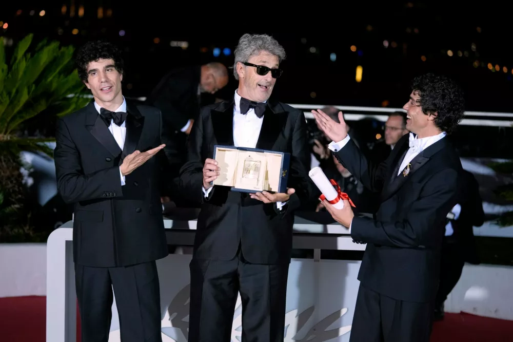 Paweł Pawlikowski, center, winner of the award for best director for 'Fatherland,' poses with Javier Calvo, left, and Javier Ambrossi, winners of the award for best director for 'La bola negra,' at the awards ceremony photo call during the 79th international film festival, Cannes, southern France, Saturday, May 23, 2026. (AP Photo/John Locher)