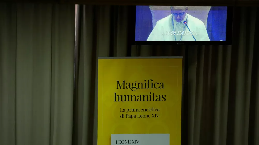 Pope Leo XIV, left, attends the presentation of his first encyclical, "Magnifica humanitas: On Safeguarding the Human Person in the Time of Artificial Intelligence," at the Vatican, Monday, May 25, 2026. (AP Photo/Alessandra Tarantino)
