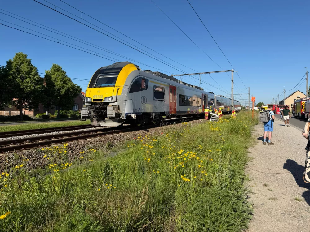 Rescue workers on the scene of a crash between a train and vehicle in Buggenhout, Belgium, Tuesday, May 26, 2026. (AP Photo/Koen Baten)